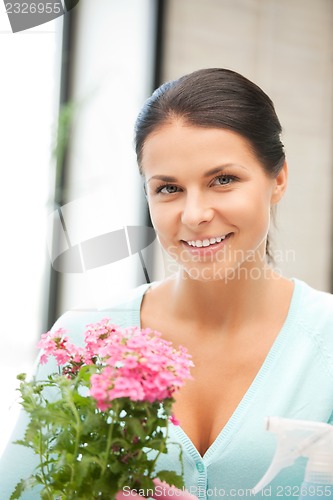 Image of lovely housewife with flower