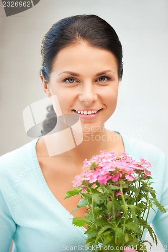 Image of lovely housewife with flower