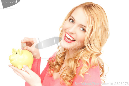 Image of lovely woman with piggy bank and money