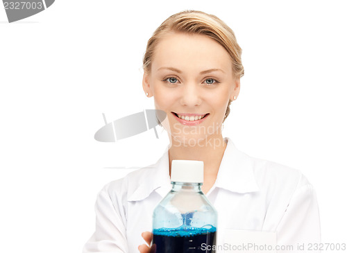 Image of lab worker holding up bottle with blue liquid