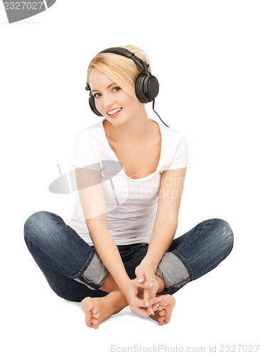 Image of  happy teenage girl in big headphones