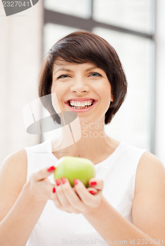 Image of lovely housewife with green apple