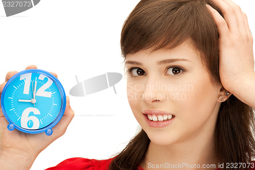 Image of teenage girl holding alarm clock