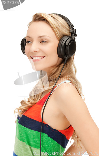 Image of happy teenage girl in big headphones