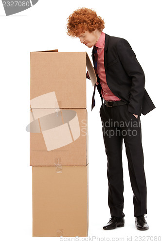 Image of attractive businessman with big boxes