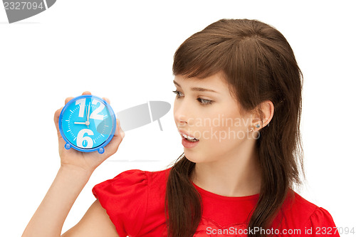 Image of teenage girl holding alarm clock