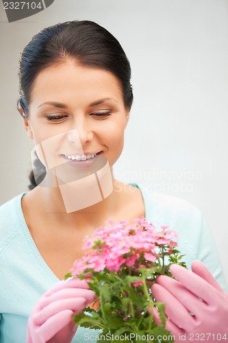 Image of lovely housewife with flower