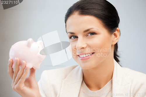 Image of lovely woman with piggy bank