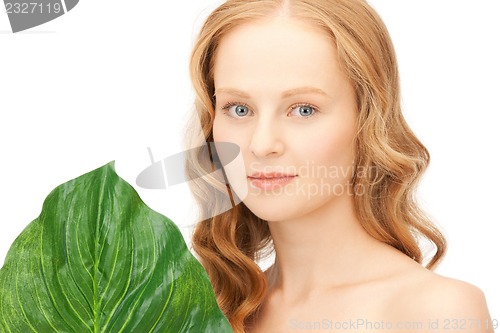 Image of woman with green leaf