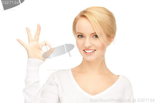 Image of lovely teenage girl showing ok sign