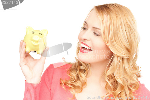 Image of lovely woman with piggy bank