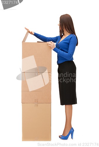 Image of attractive businesswoman with big boxes