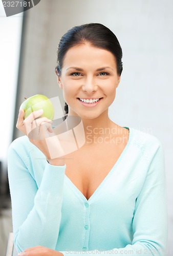 Image of lovely housewife with green apple