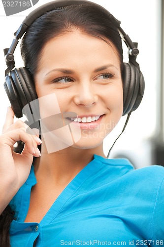 Image of happy teenage girl in big headphones
