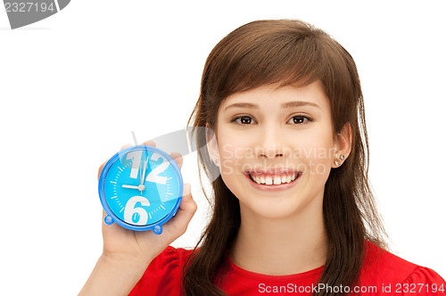 Image of teenage girl holding alarm clock