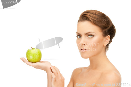 Image of young beautiful woman with green apple