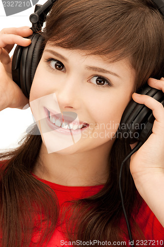 Image of happy teenage girl in big headphones