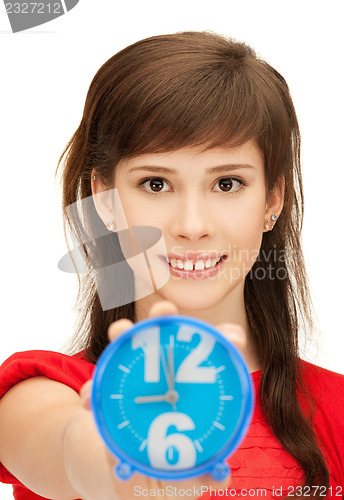 Image of teenage girl holding alarm clock