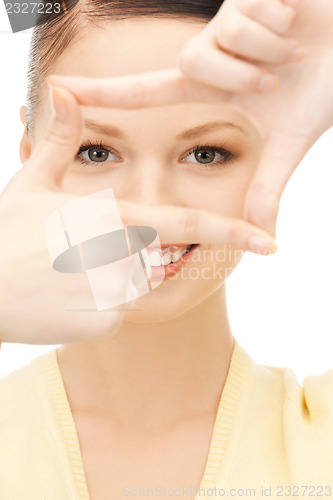 Image of lovely woman creating a frame with fingers