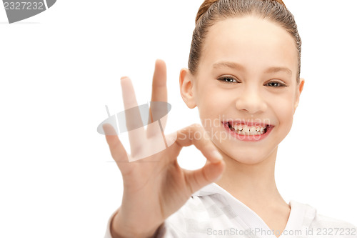 Image of lovely teenage girl showing ok sign