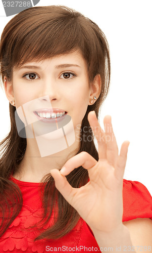 Image of lovely teenage girl showing ok sign