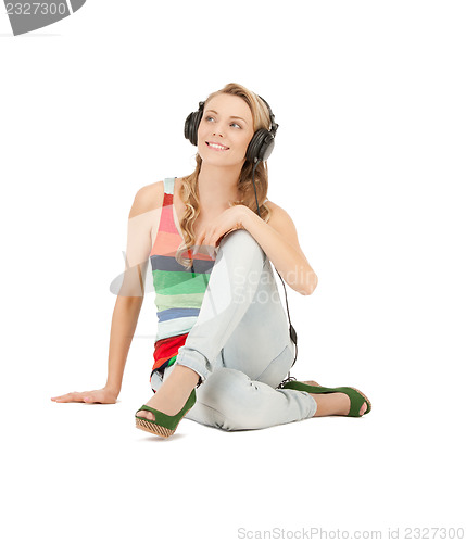 Image of happy teenage girl in big headphones