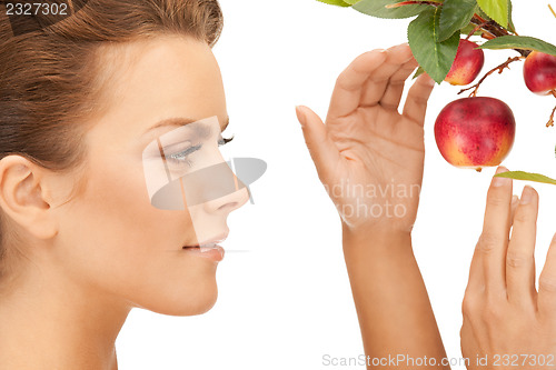 Image of lovely woman with apple twig