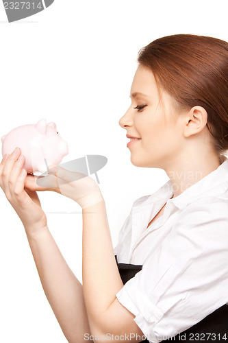 Image of lovely woman with piggy bank