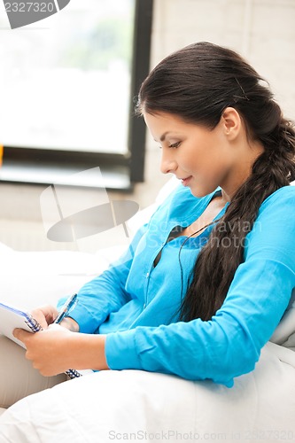 Image of calm woman with big notepad