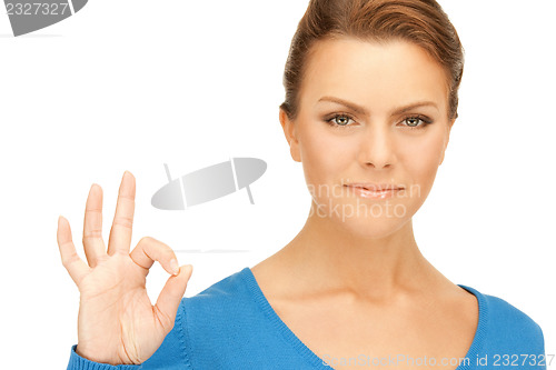 Image of lovely teenage girl showing ok sign