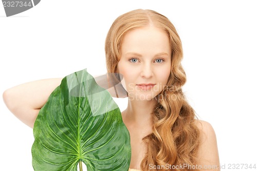 Image of woman with green leaf