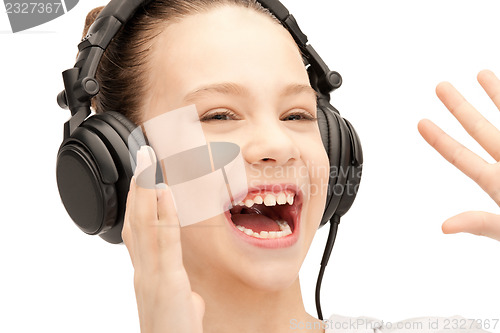 Image of happy teenage girl in big headphones