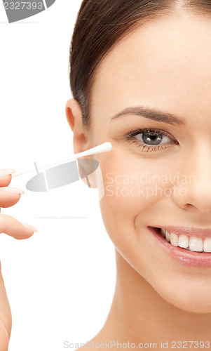 Image of beautiful woman with cotton bud