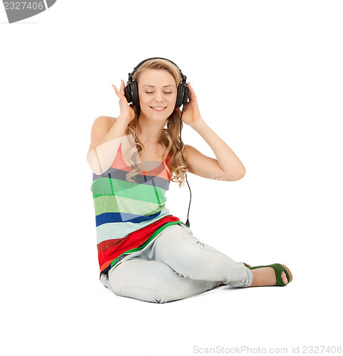 Image of happy teenage girl in big headphones