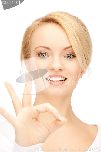 Image of lovely teenage girl showing ok sign