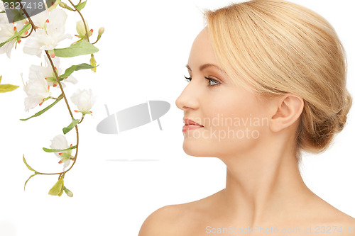Image of beautiful woman with orchid flower