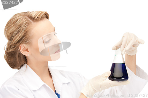 Image of lab worker holding up test tube