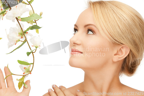 Image of beautiful woman with orchid flower