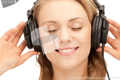 Image of happy teenage girl in big headphones