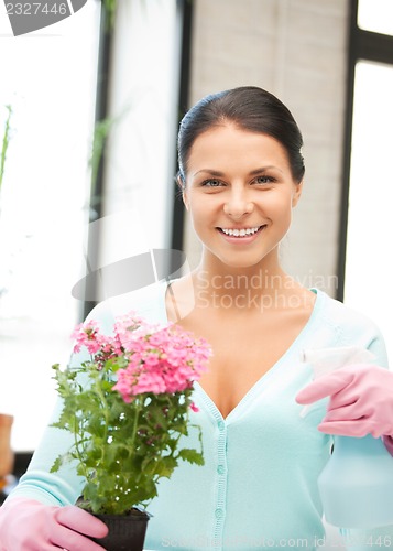 Image of lovely housewife with flower