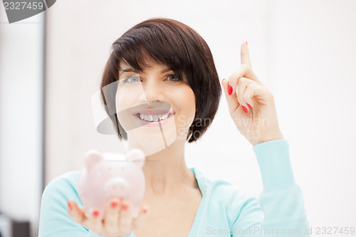 Image of lovely woman with piggy bank