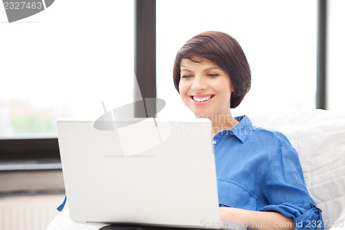 Image of happy woman with laptop computer