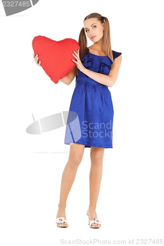 Image of lovely woman with red heart-shaped pillow