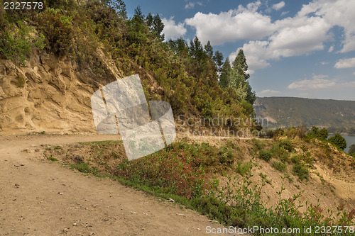 Image of Dirt road going around the hills