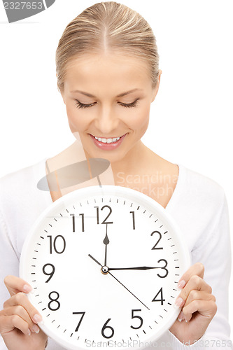 Image of woman holding big clock