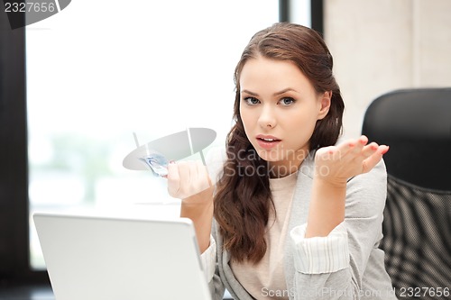 Image of unhappy woman with computer and euro cash money