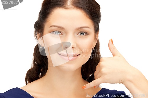 Image of woman making a call me gesture
