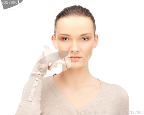 Image of woman making a call me gesture