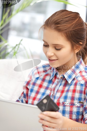 Image of happy woman with laptop computer and credit card