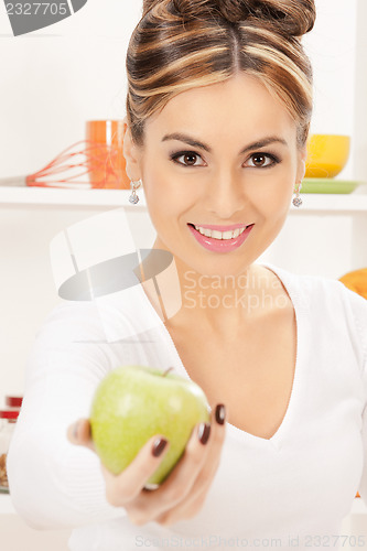 Image of lovely housewife with green apple